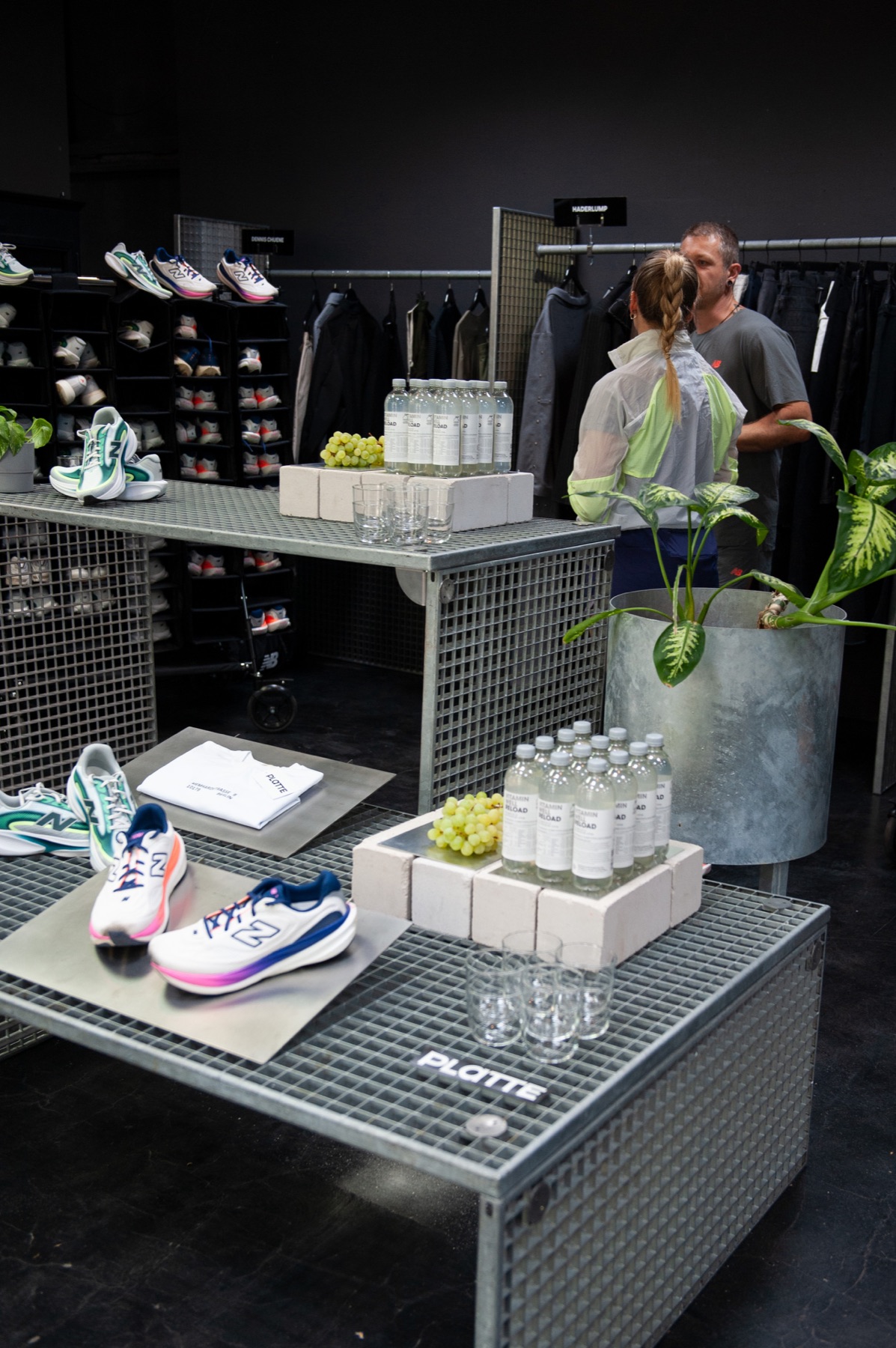 New Balance running shoes and water bottles set out on mesh crates at the runners' base